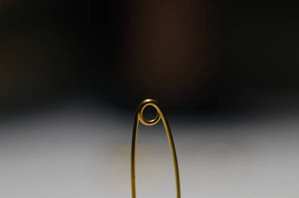 istock gold paper clip in close-up. 2060758257