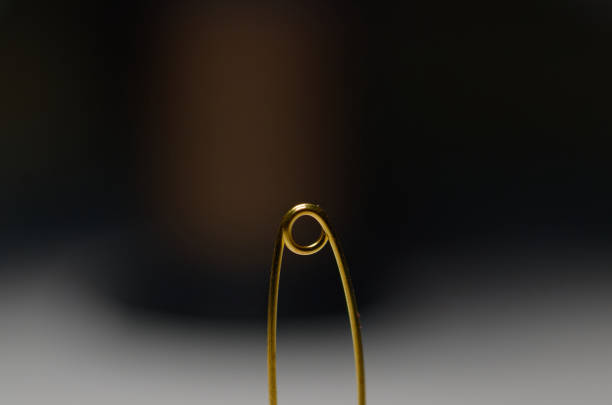 istock gold paper clip in close-up. 2060762374