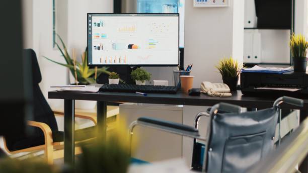 istock Company workspace with nobody in and marketing pie charts on computer monitors 2060764022