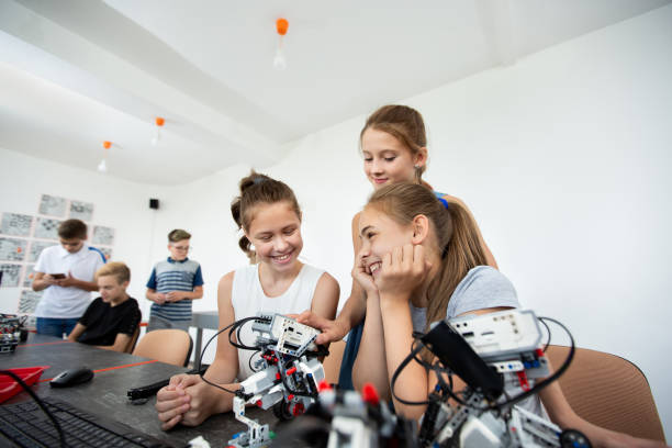 istock Group of happy kids with laptop computer building robots at robotics school lesson 2060770607
