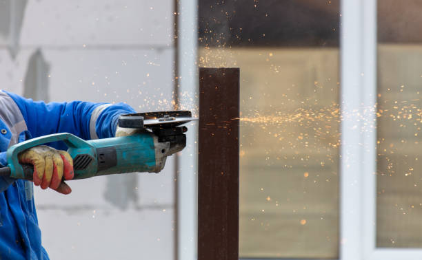 istock A worker is cutting metal to install a fence 2060770630