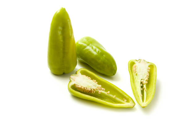 Two whole and half of green bell pepper (capsicum) known as sweet bell pepper, paprika isolated on white background. Vegetables collection.