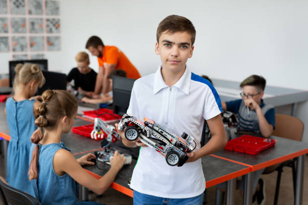 istock Portrait Of Male Student Building Robot Vehicle In After School Computer Coding Class. 2060777300