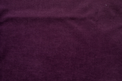 Purple magenta silk satin velvet. Beautiful soft wavy folds. Table top view. Flat lay. Shiny fabric backdrop with copy space for design, montage. Christmas, Valentine.