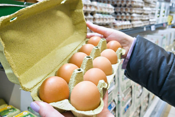 istock Hand with packages of eggs in store 2060785026