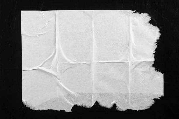 istock Old torn poster with folds on a black background. 2060785557