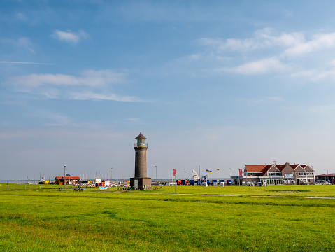 The red lighthouse and some houses near De Cocksdorp on the island of Texel in the Dutch Waddensea.