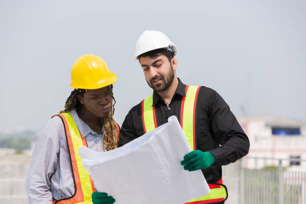 istock Male and female foreman builder working together at construction site. Male engineer construction working at construction site. Female engineer working at construction site 2060793115