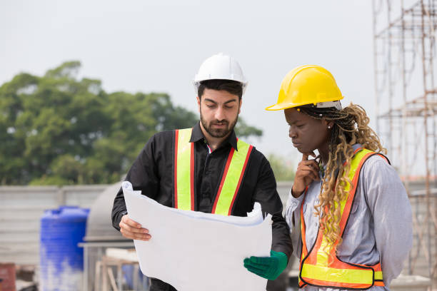 istock Male and female foreman builder working together at construction site. Male engineer construction working at construction site. Female engineer working at construction site 2060793625
