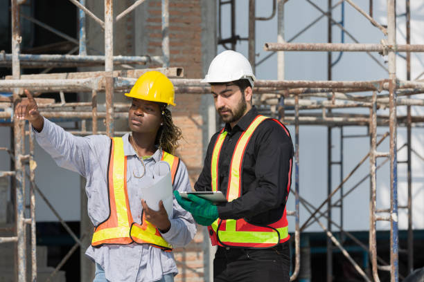 istock Male and female foreman builder working together at construction site. Male engineer construction working at construction site. Female engineer working at construction site 2060794131