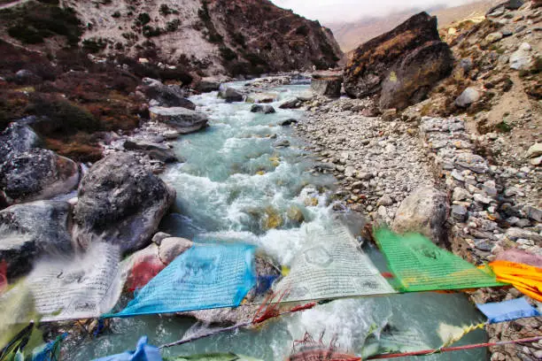 Prayer flags flutter along the many small bridges over Himalayan streams on the Everest base camp trail in Nepal
