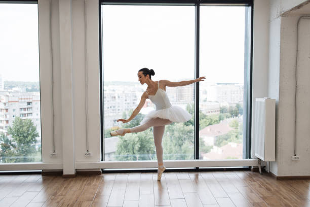 istock Caucasian ballerina posing in bright class studio with panoramic windows 2060813219