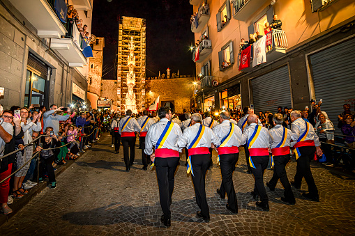Viterbo, Lazio, Italy - 3 September 2019:\n  The procession has always been well followed and along the route thousands of people find themselves cheering on the Porters (dressed in the traditional white uniform with a red sash at the waist in which the white symbolizes the purity of spirit of the patron saint and the red the cardinals who in 1258 moved his body) in an extraordinary test of strength and faith.