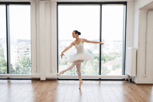 istock Young graceful ballet dancer rehearsing performance in white spacious hall. 2060813538