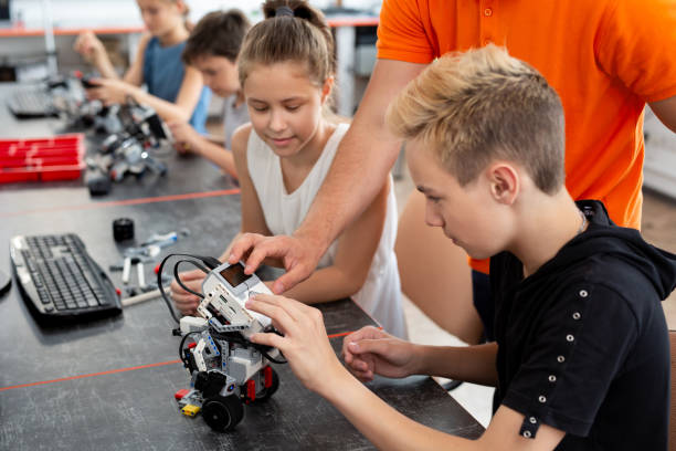 istock Kids working with teacher on their robot education project. 2060813566