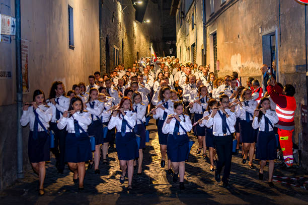 Ronneby, Sweden - June 16, 2018: Upper secondary school graduation day. Happy students running toward the city square to meet their relatives and friends. Flag waving in the background.