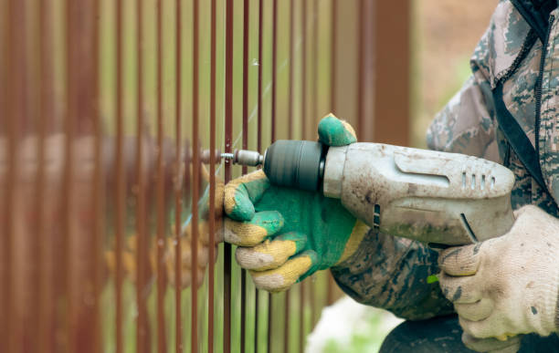 istock Workers install a metal profile fence 2060817843