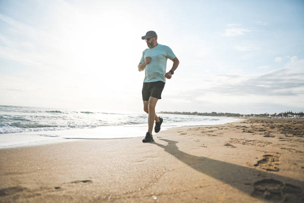 istock Man walking and doing sports on the beach 2060817855