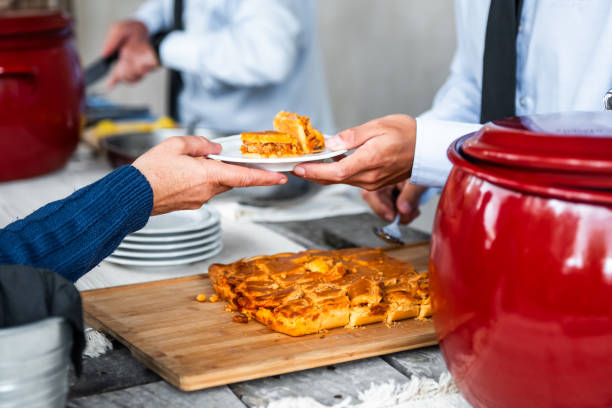 istock A waiter delivering a plate with empanada to a customer, at an event in a restaurant, 2060818827