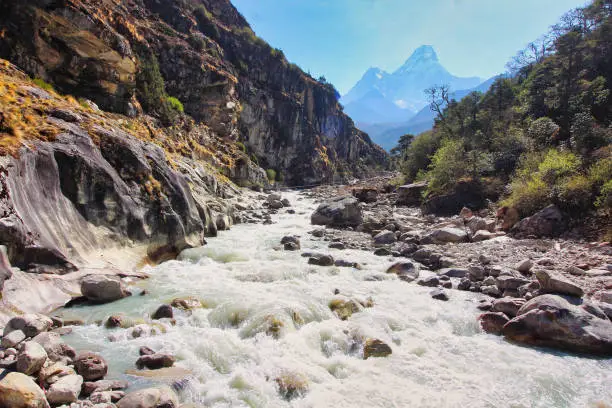 Scenic view of Ama Dablam rising from the mists in the deep valleys of the Dudh kosi river in Nepal