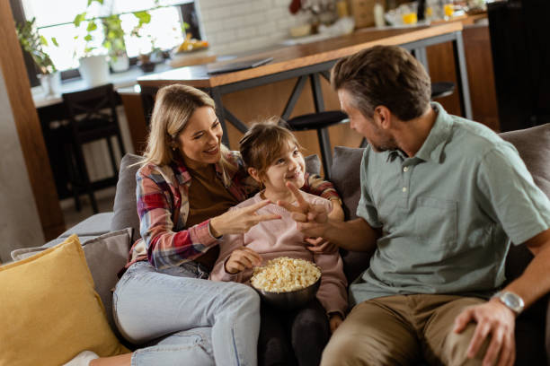 istock Cozy family time: sharing laughter and popcorn on a casual evening 2060836052