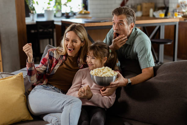istock Family Movie Night: Engrossed in Thrilling Scenes at Home 2060836573