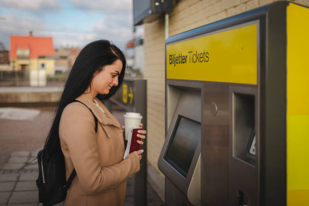 istock Smiling businesswoman purchasing a train ticket 2060881036