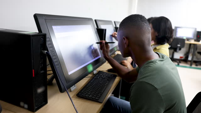Students editing images during class using technology