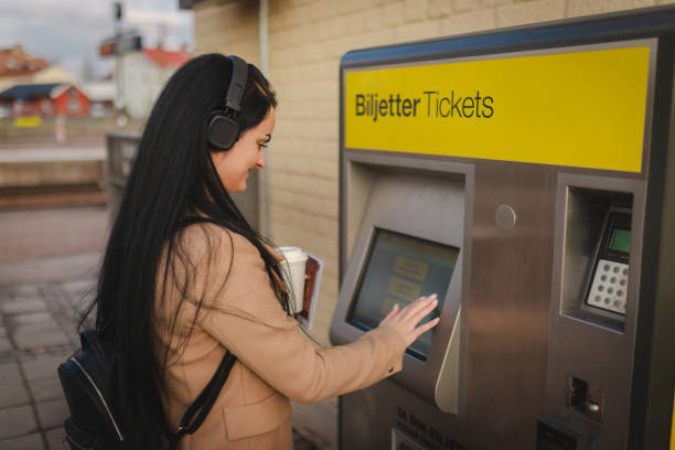 istock Smiling businesswoman purchasing a train ticket 2060881119