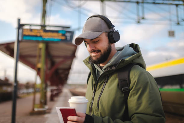 istock Young man waiting for the train at the railroad station 2060887178