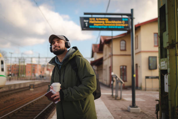 istock Young man looking for his train at the railroad station 2060887731