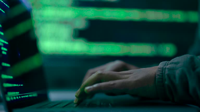 Close up hacker hand typing on computer to hacking break in to confidential data in data center.