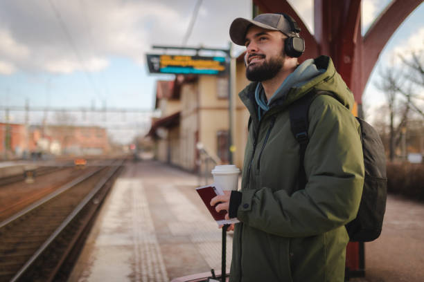 istock Smiling man waiting for the train 2060890479