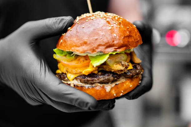 istock chef hand cooking cheese burger on restaurant kitchen 2060899319