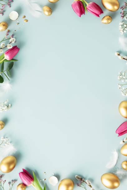istock Happy Easter concept with golden easter eggs, feathers and spring flowers 2060902578