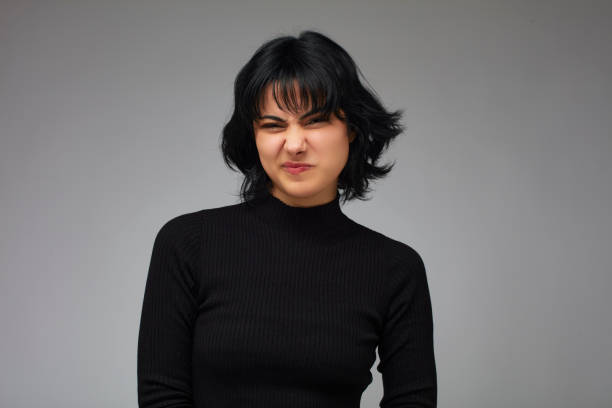 Grimacing, dissatisfied short-haired brunette woman.
