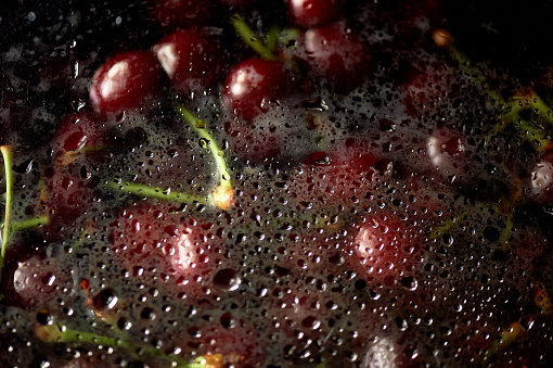 Juicy cherries or cherries in the water under the fogged glass. Vitamins and berries. Juiciness.