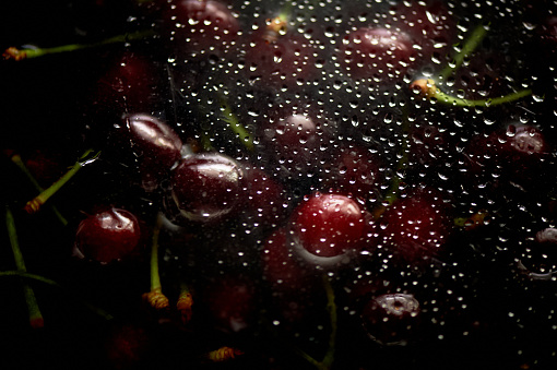 Juicy cherries or cherries in the water under the fogged glass. Vitamins and berries. Juiciness.