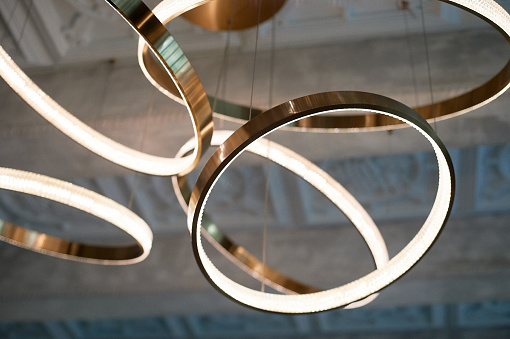 Chandelier on the concrete ceiling. Circles or rings. Luminaire design
