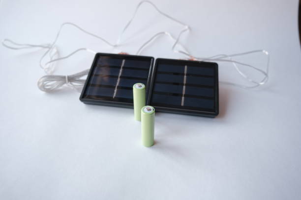 istock Rechargeable AA batteries. mini solar panel on the background. AA battery charger based on solar panels. free solar power for small projects 2060947002