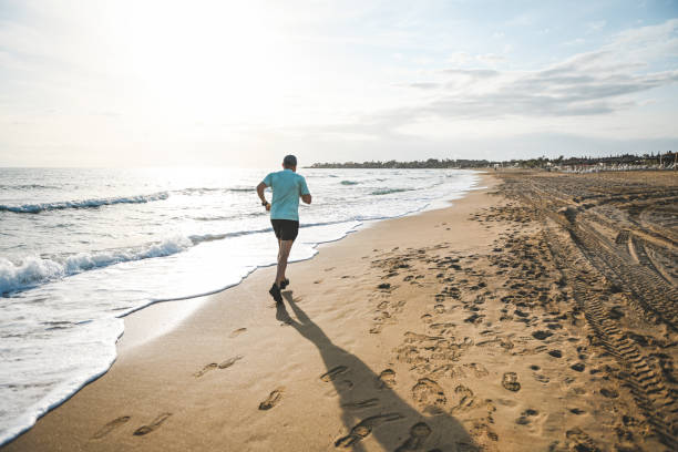 istock Man walking and doing sports on the beach 2060948088