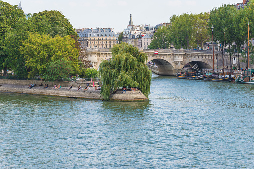 Paris, France; 08.22.2018: Beautiful landscape of the Pont Neuf and Ile de la Cité from the Seine river by sunny summer day