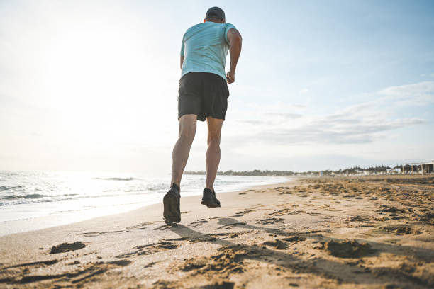 istock Man walking and doing sports on the beach 2060962707