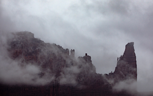 Fog has enveloped the Fisher Towers on Bureau Of Land Management's the Fisher Towers National Recreation Trail near Moab, Utah