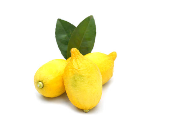 A ripe lemon with a knife on a chopping board
