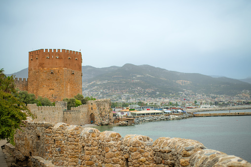 Kizil Kule tower in Alanya, Turkey, part of old castle, sea and harbor