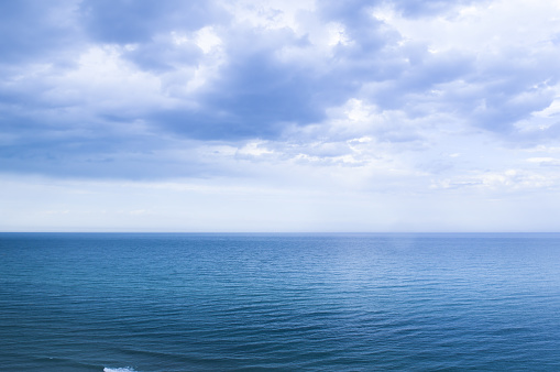 Calm windless ocean in blue tones. Seascape.