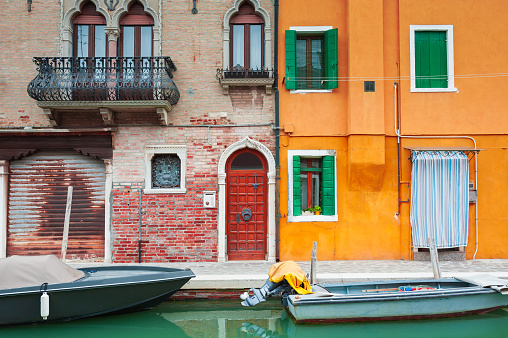 Colorful architecture on the canal in Burano island, Venice, Italy. Famous travel destination.