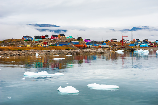 Western Greenland. Colorful houses on the rocks in Saqqaq village on the coast of Atlantic ocean. Summer landscape