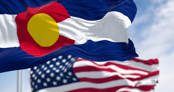 istock Colorado and US flags waving in the wind on a clear day 2061018981
